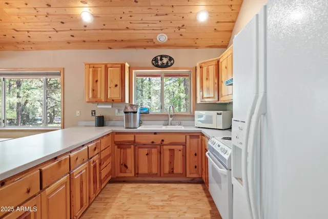 a kitchen with a window a sink and a granite counter tops