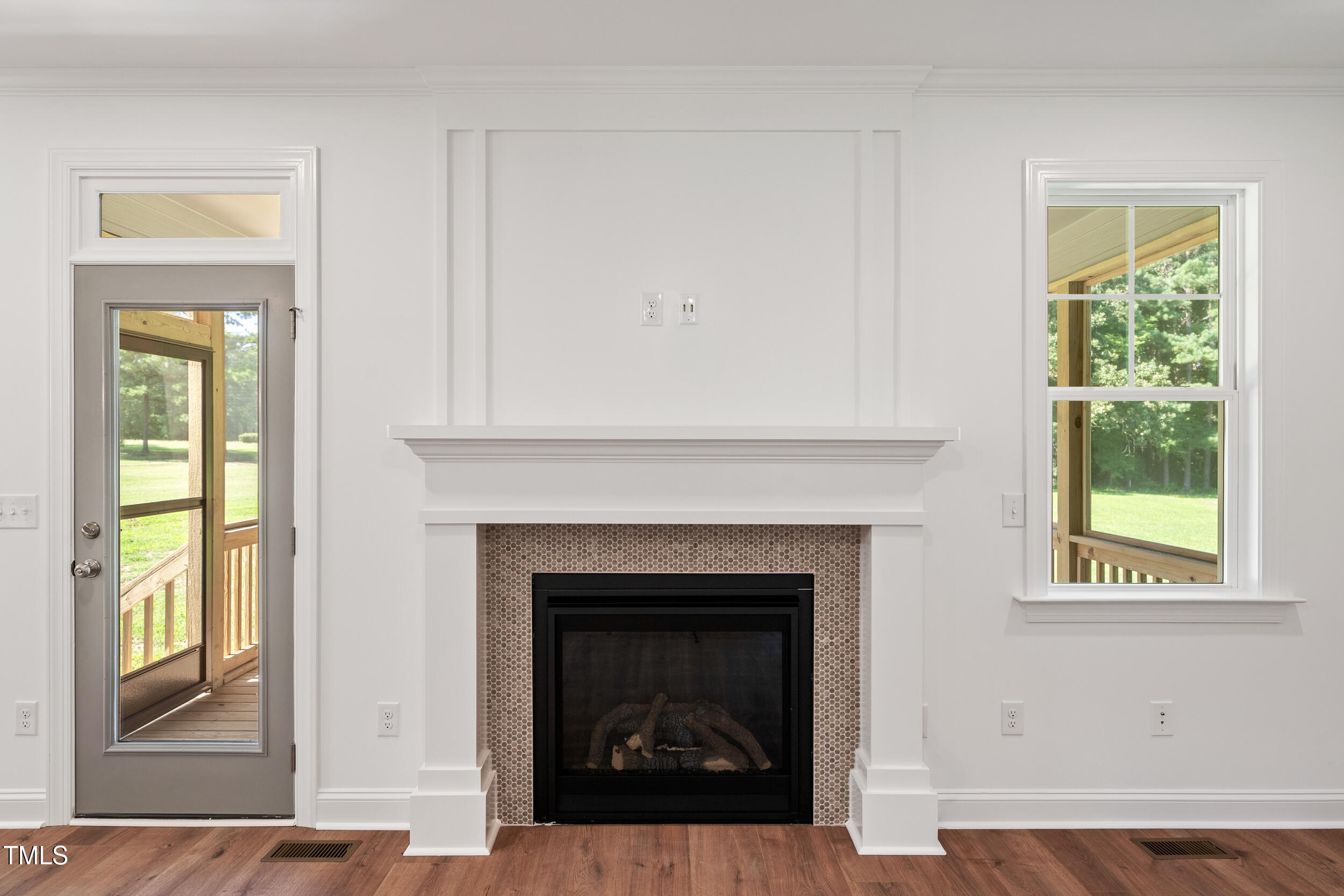1693 Will Suitt Road Butner, NC 27522 - Photo 15 of 41 a living room with a fireplace and windows
