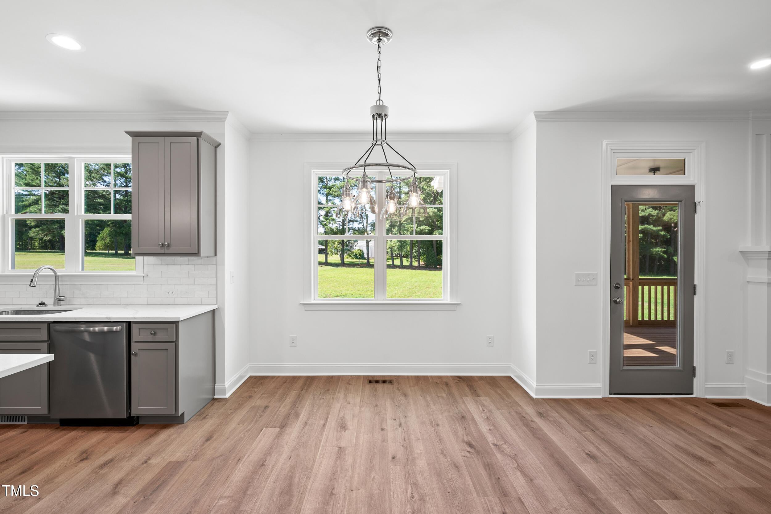 1693 Will Suitt Road Butner, NC 27522 - Photo 19 of 41 a kitchen with kitchen island granite countertop a sink window and cabinets