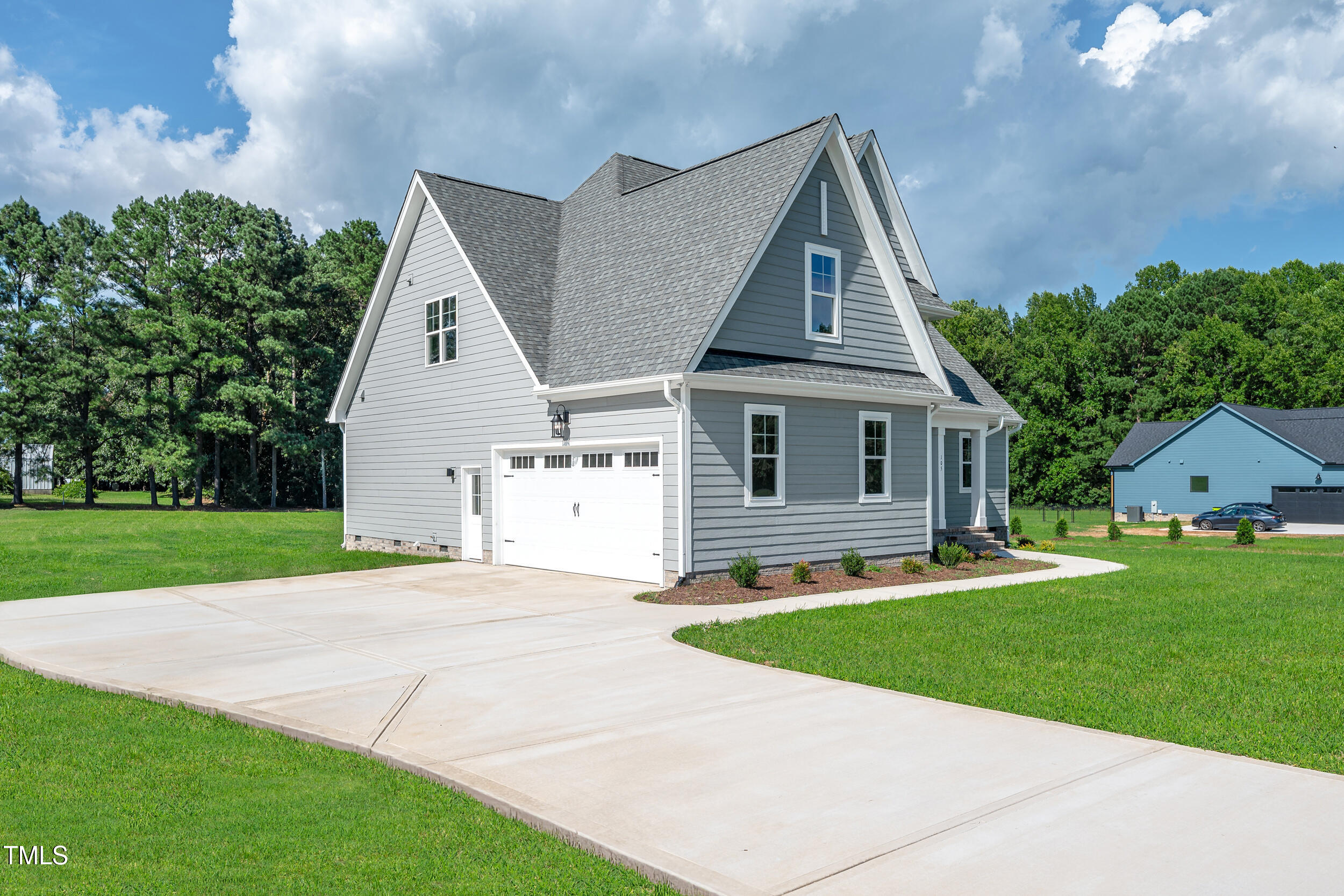 1693 Will Suitt Road Butner, NC 27522 - Photo 3 of 41 a front view of a house with a yard and garage