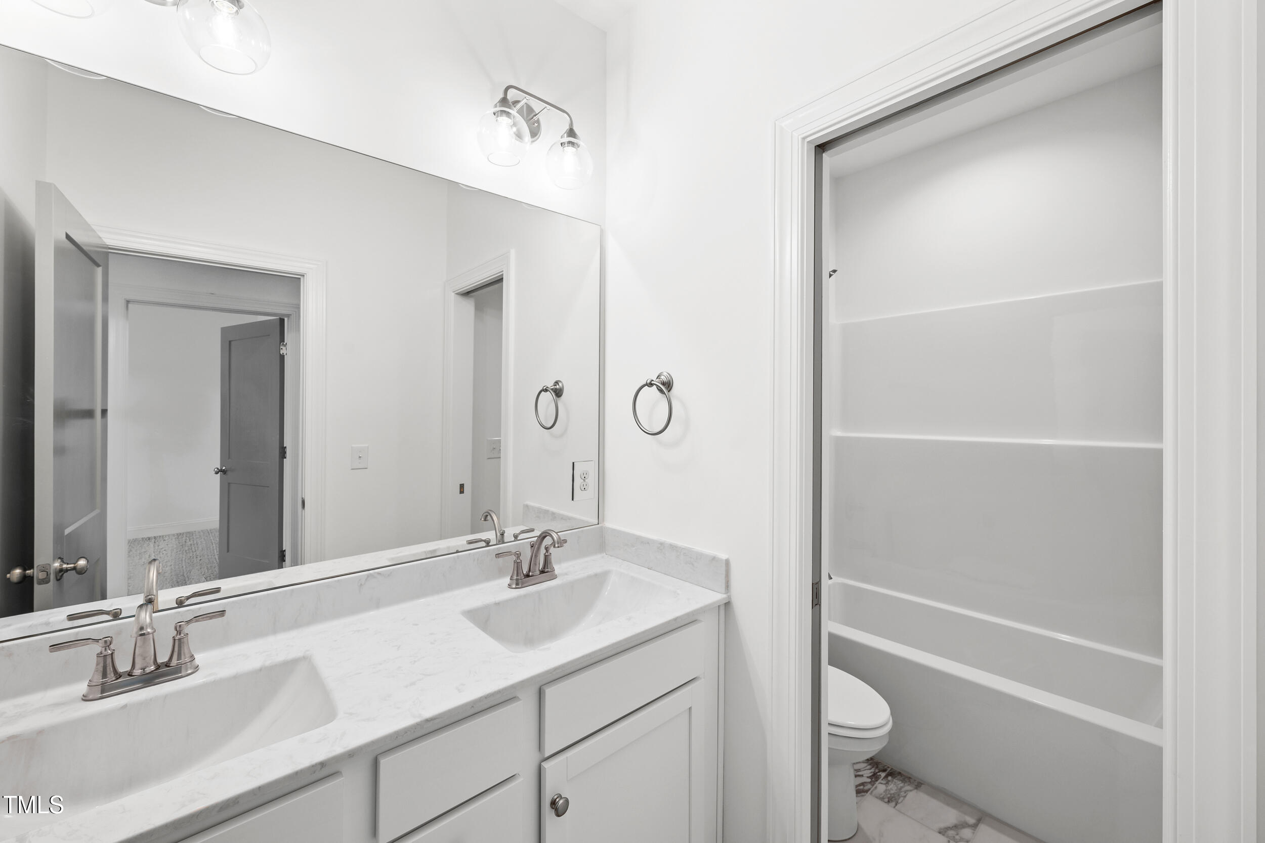 1693 Will Suitt Road Butner, NC 27522 - Photo 35 of 41 a bathroom with a sink toilet vanity and shower