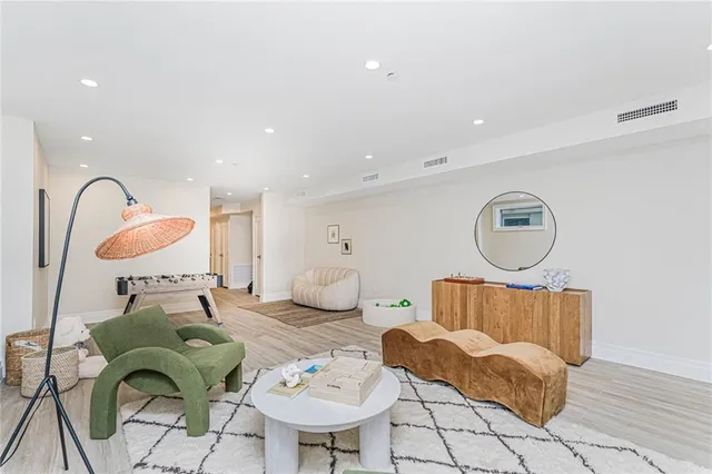 a living room with furniture flowerpot and window