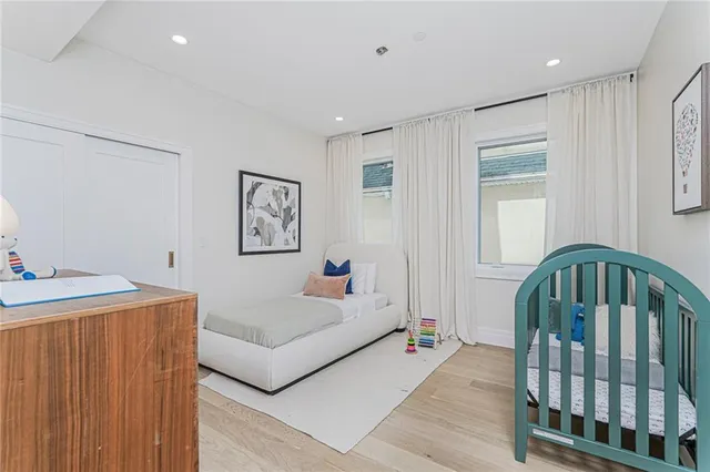 a living room with furniture and baby crib