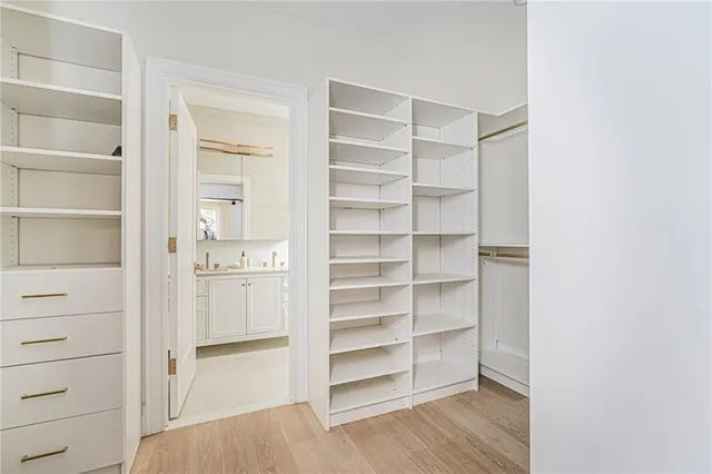 a view of walk in closet with empty racks