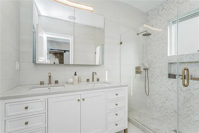 a bathroom with a double vanity sink mirror and