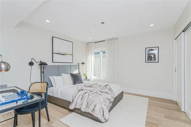 a bedroom with a bed and a chair