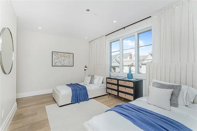 a bedroom with furniture and wooden floor