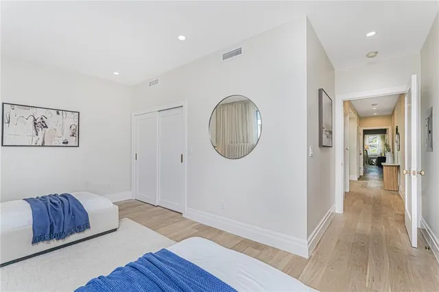 a view of a hallway with entryway wooden floor and front door
