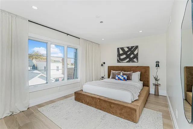 a bedroom with a large bed and a large window