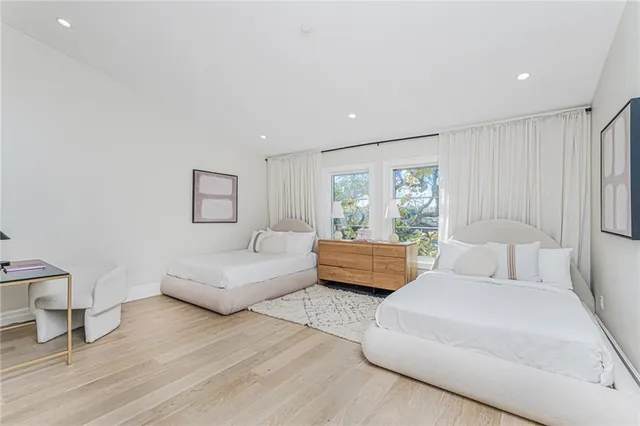a bedroom with furniture and wooden floor