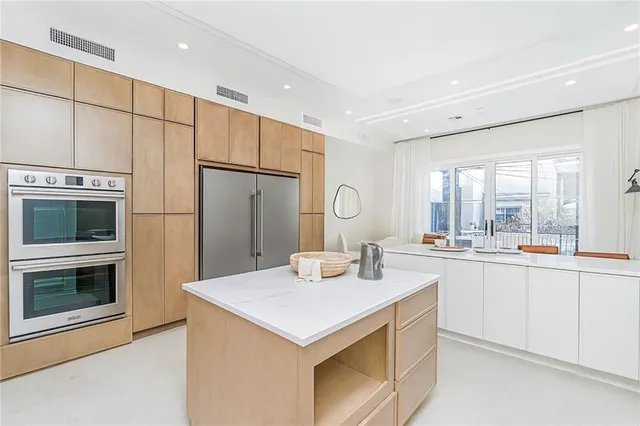 a kitchen with stainless steel appliances granite countertop a stove a sink and a refrigerator