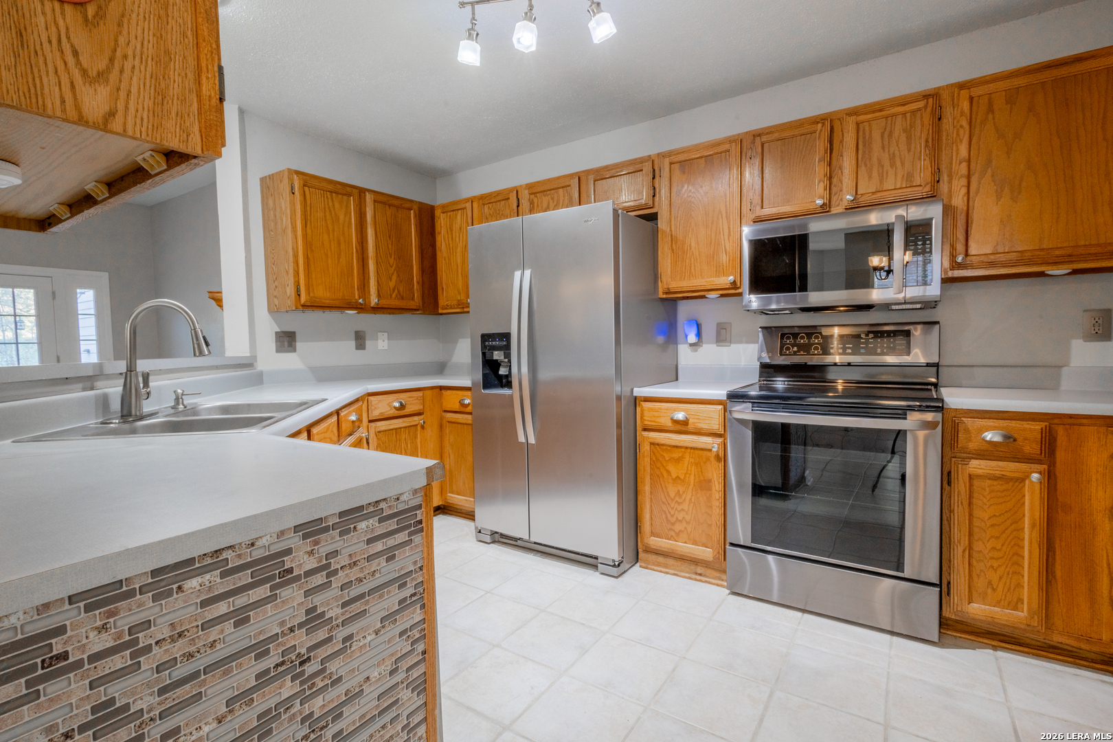 14 Oak Villa Road, Unit G5 Canyon Lake, TX 78133 - Photo 11 of 27 a kitchen with stainless steel appliances granite countertop a refrigerator stove and sink