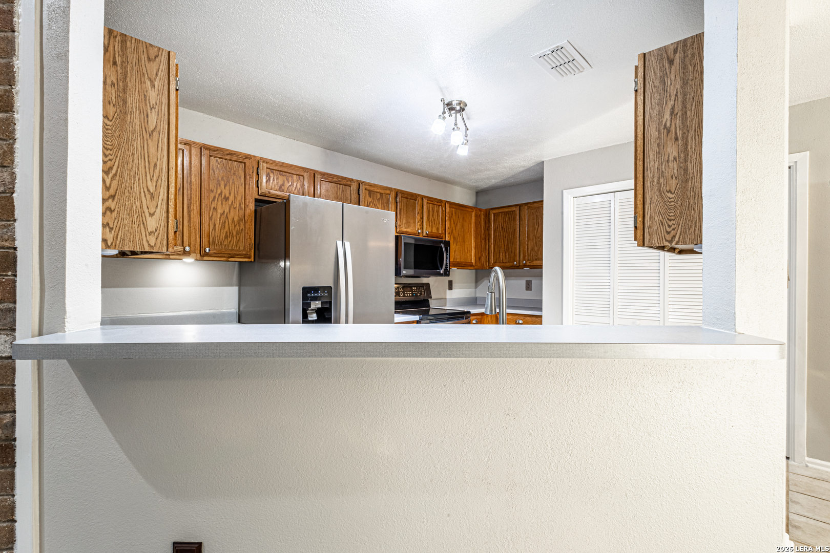 14 Oak Villa Road, Unit G5 Canyon Lake, TX 78133 - Photo 12 of 27 a view of a kitchen with a sink and a refrigerator
