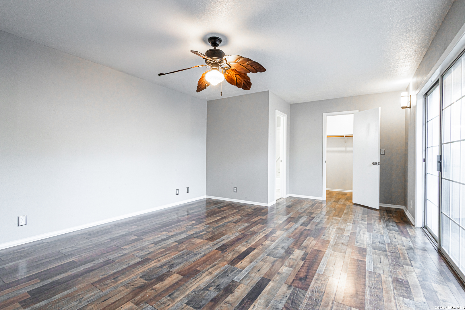 14 Oak Villa Road, Unit G5 Canyon Lake, TX 78133 - Photo 15 of 27 a view of an empty room with wooden floor and windows