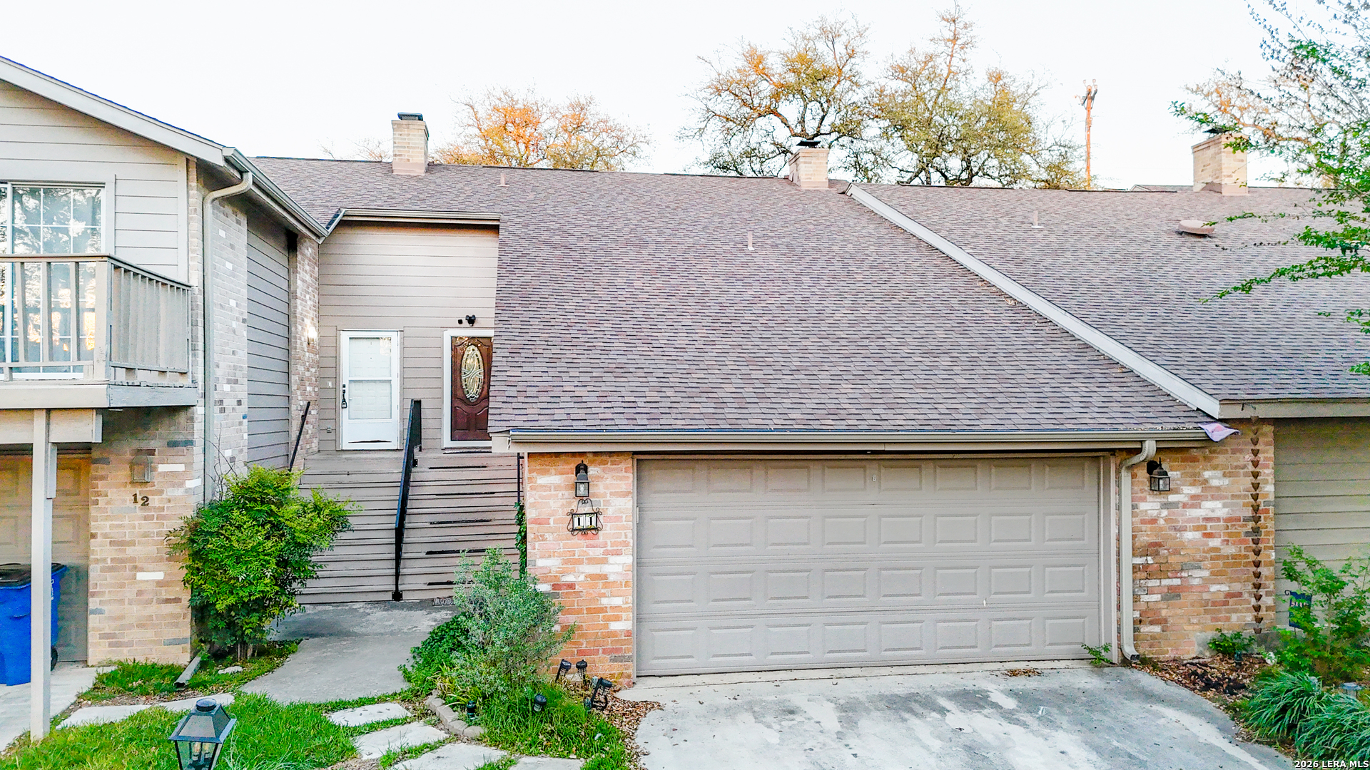 14 Oak Villa Road, Unit G5 Canyon Lake, TX 78133 - Photo 2 of 27 a front view of a house with a yard and garage