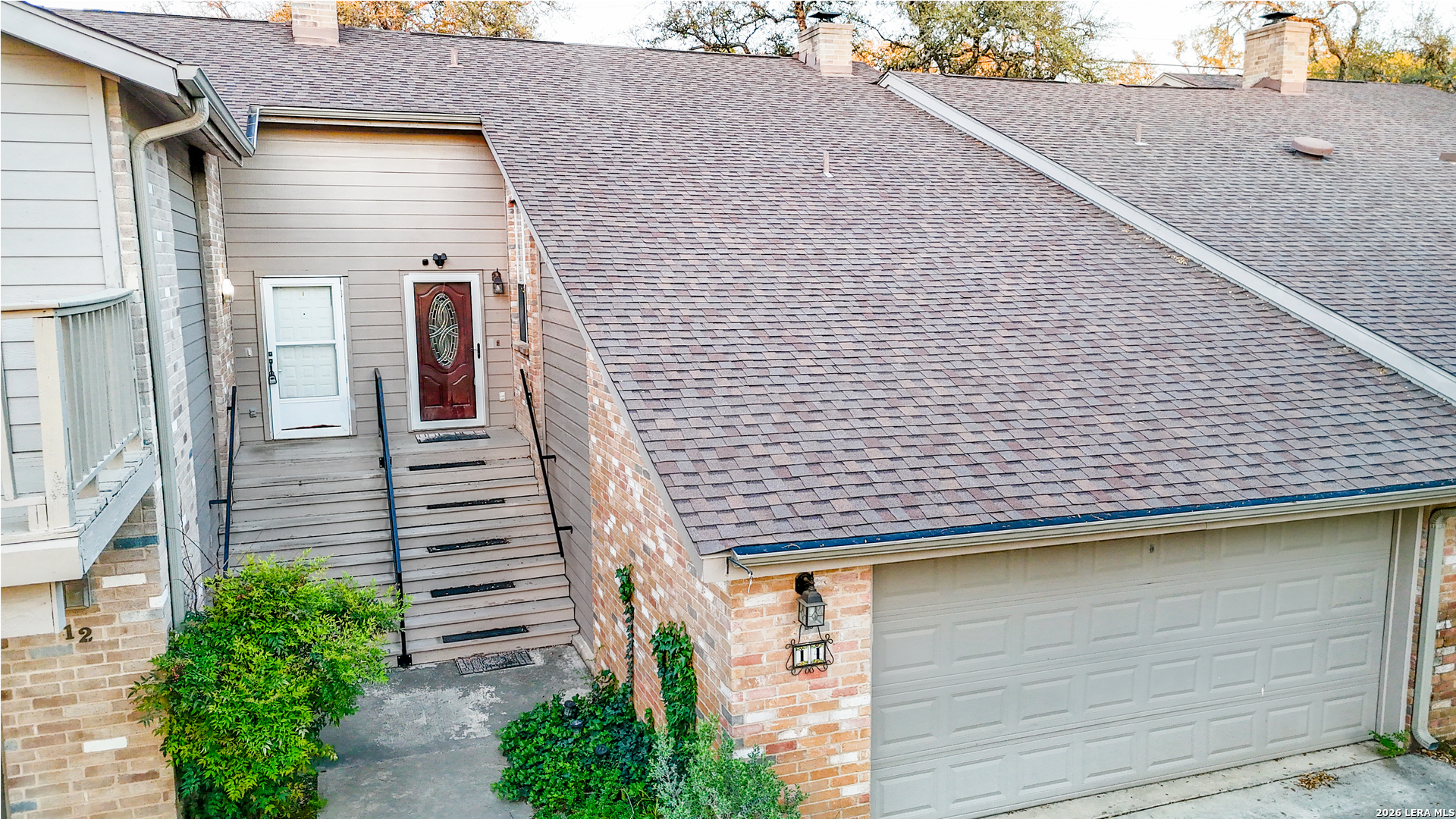 14 Oak Villa Road, Unit G5 Canyon Lake, TX 78133 - Photo 5 of 27 a brick house with stairs and plants