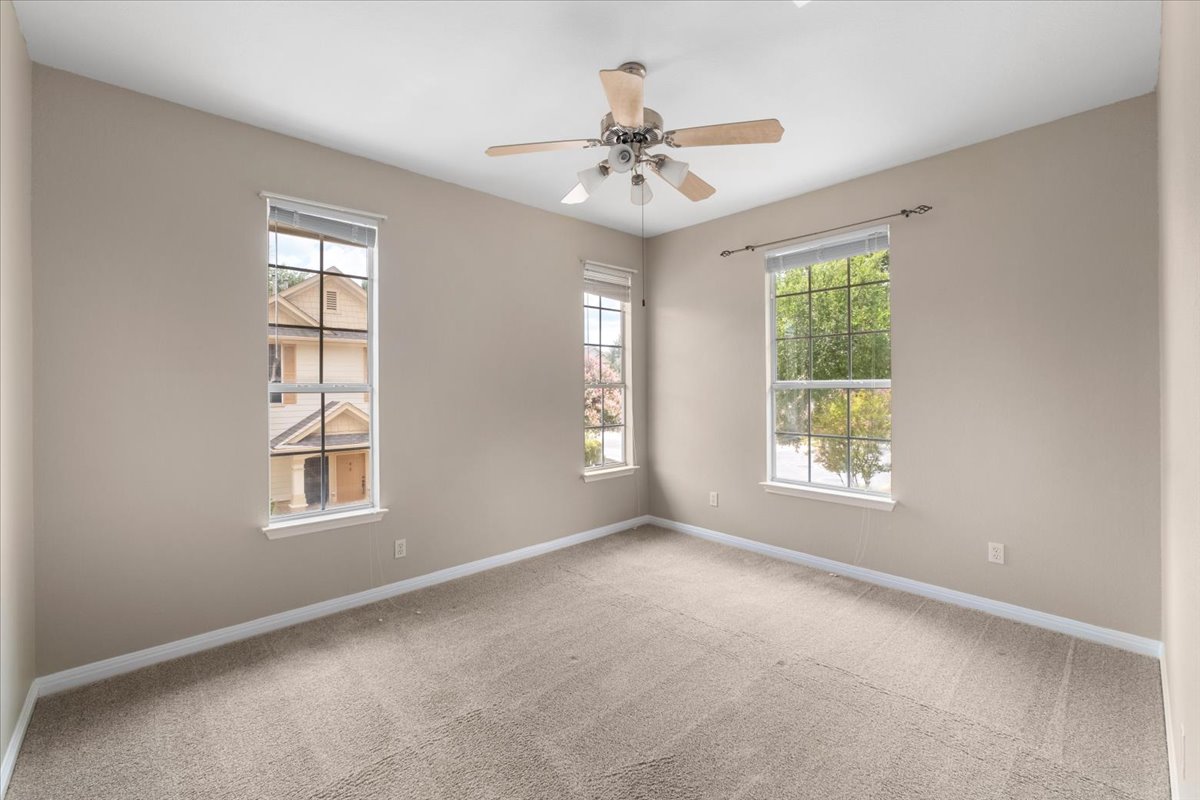 11000 Anderson Mill Road, Unit 11 Austin, TX 78750 - Photo 18 of 34 An inviting room with plush carpeting and abundant natural light from multiple windows.