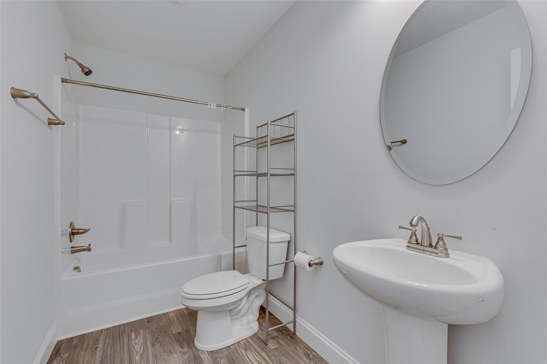 141 Capslock Trail Pendleton, SC 29670 - Photo 37 of 38 A well-appointed bath features a shower-tub combination, pedestal sink, and modern flooring.