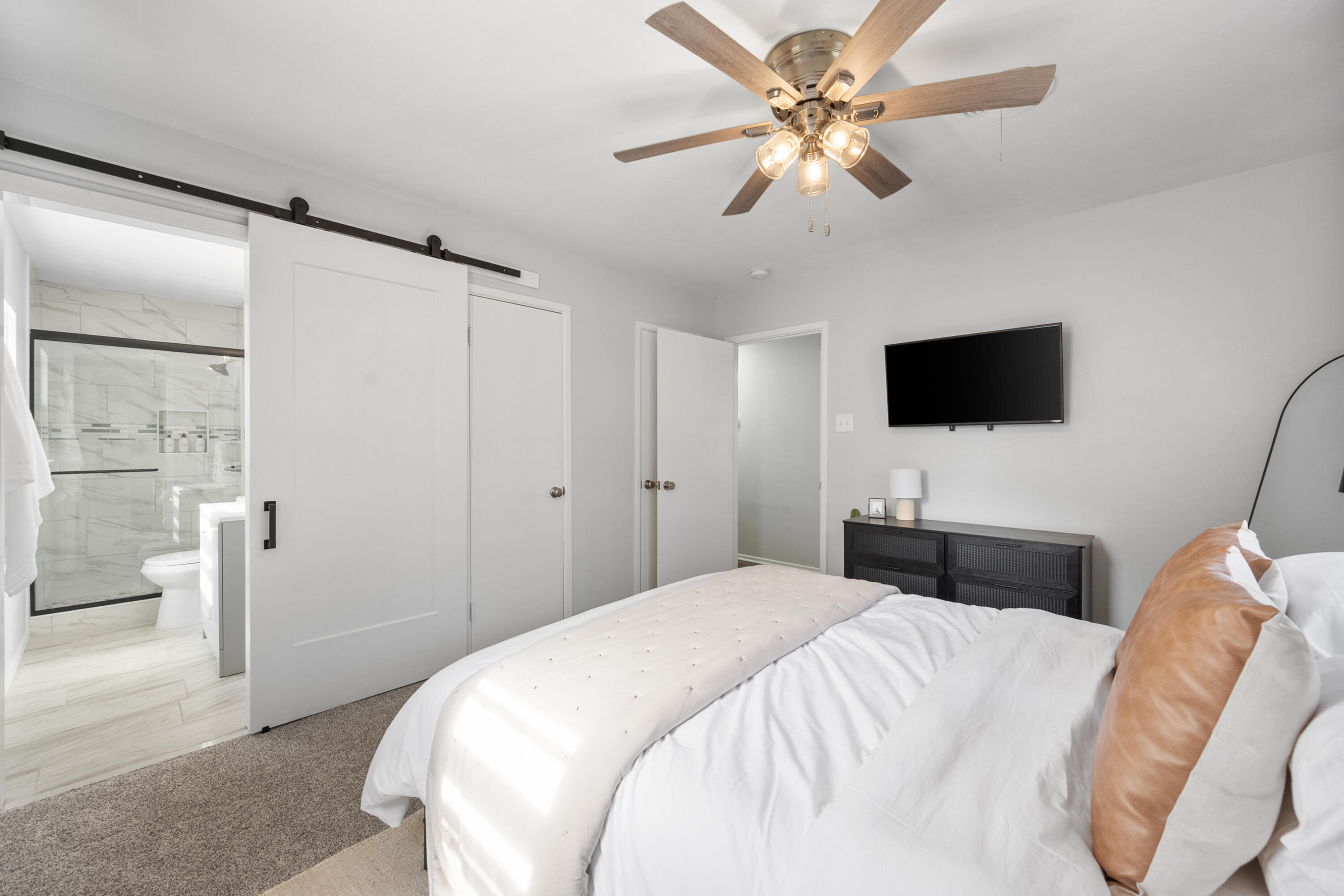 5421 43rd Street Lubbock, TX 79414 - Photo 16 of 40 a bedroom with a bed and a flat screen tv