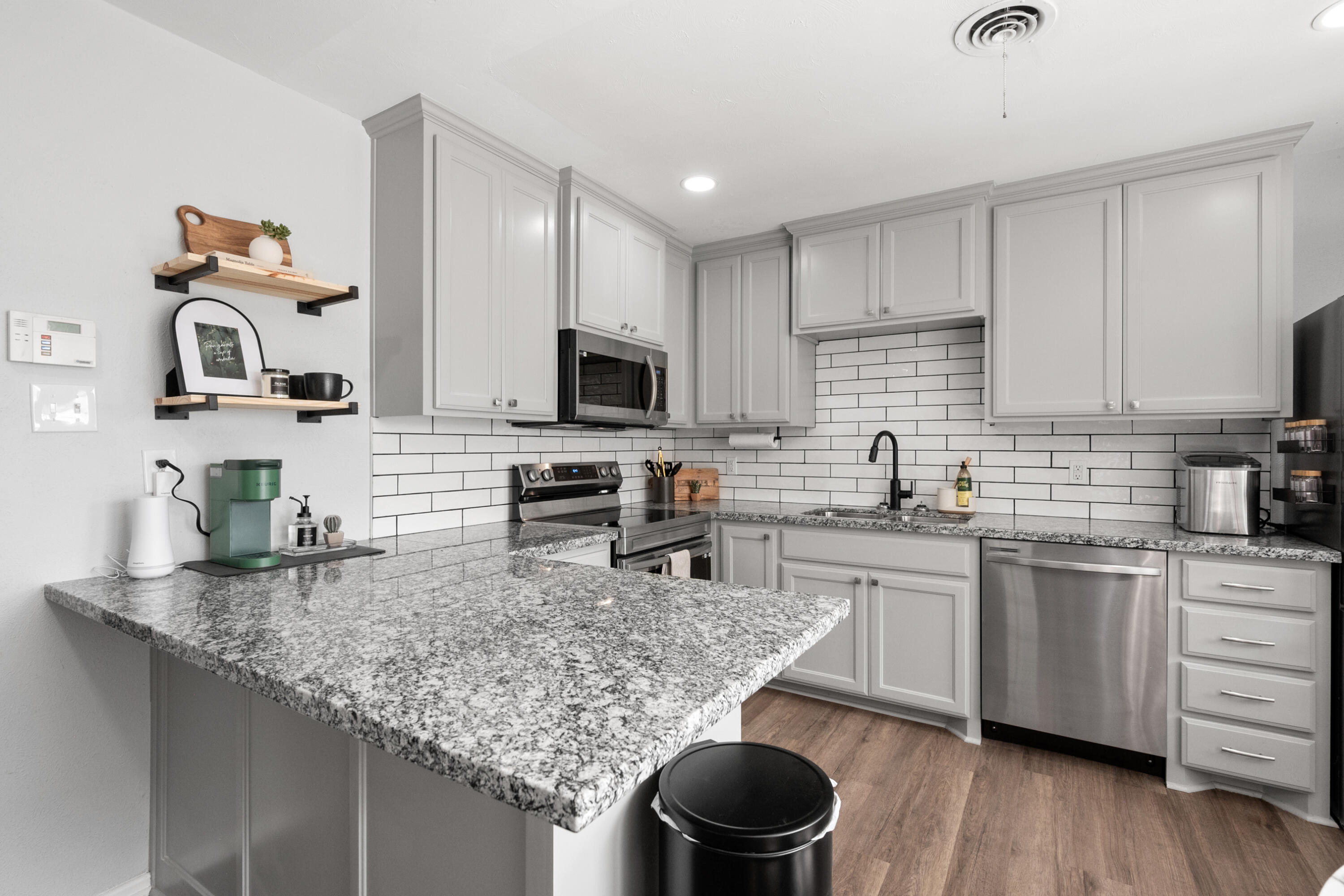 5421 43rd Street Lubbock, TX 79414 - Photo 24 of 40 a kitchen with kitchen island granite countertop a sink and appliances