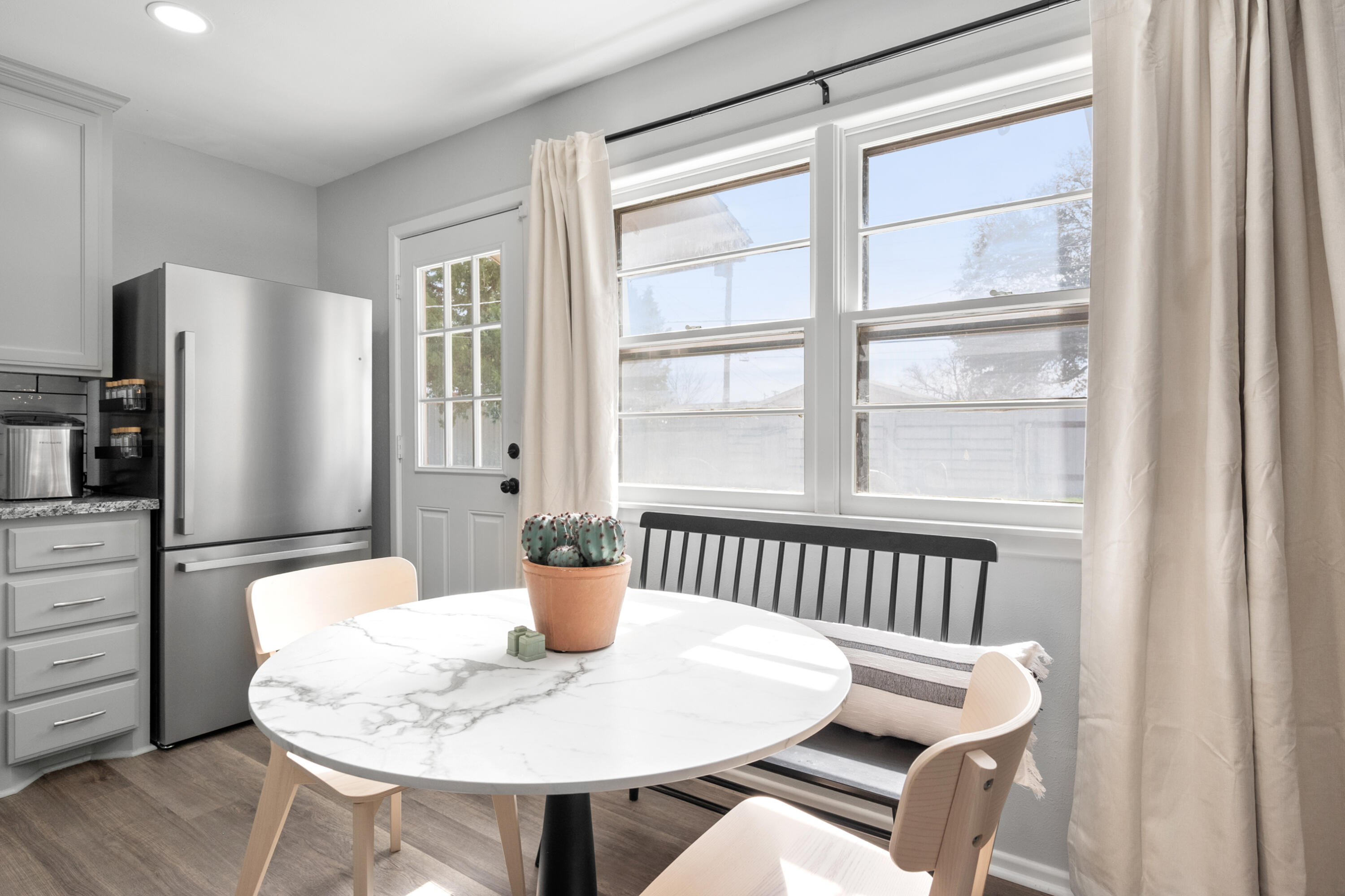 5421 43rd Street Lubbock, TX 79414 - Photo 25 of 40 a dining room with furniture a potted plant and wooden floor