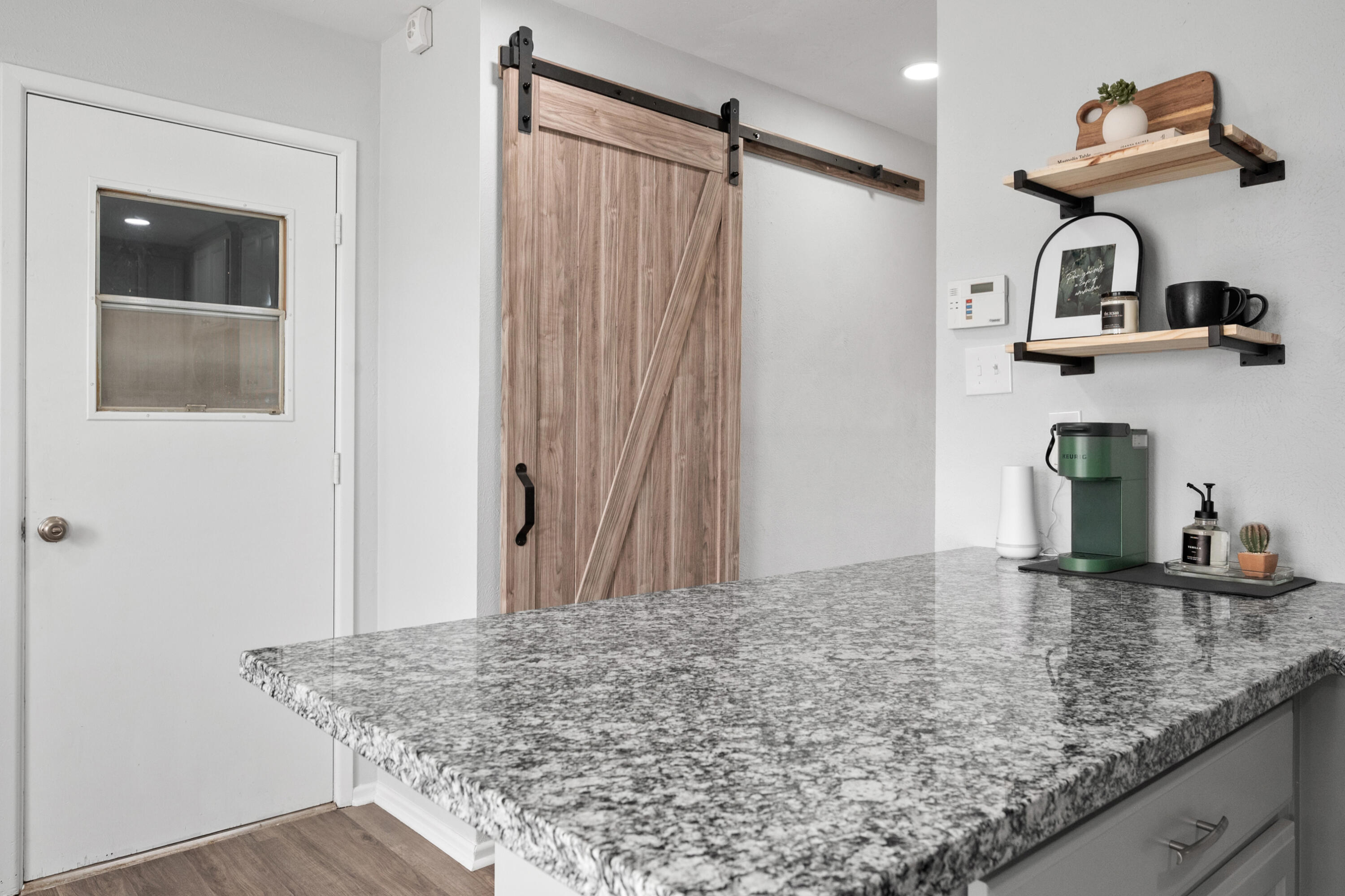 5421 43rd Street Lubbock, TX 79414 - Photo 29 of 40 a kitchen with kitchen island a sink and refrigerator