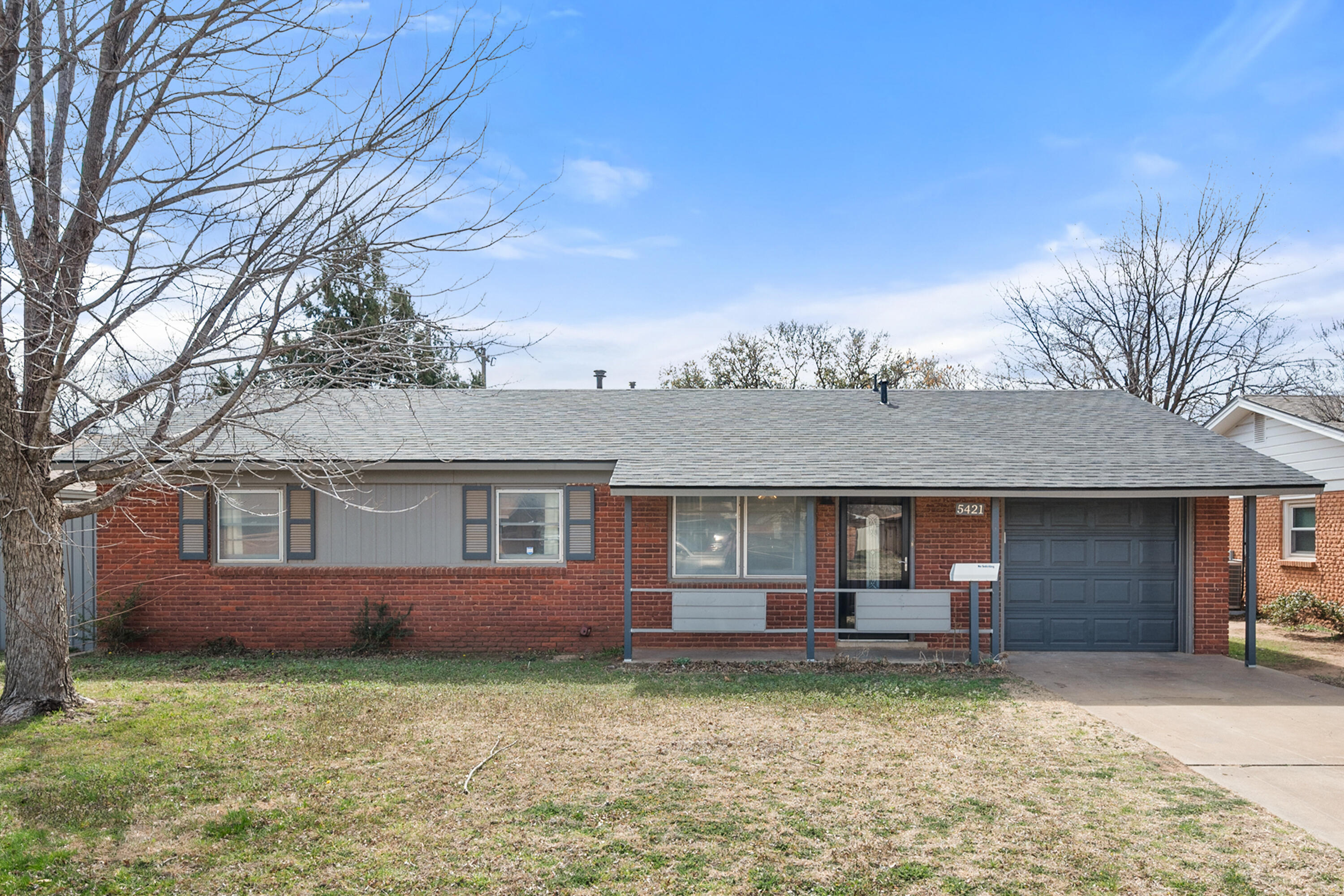 5421 43rd Street Lubbock, TX 79414 - Photo 3 of 40 front view of a house with a yard