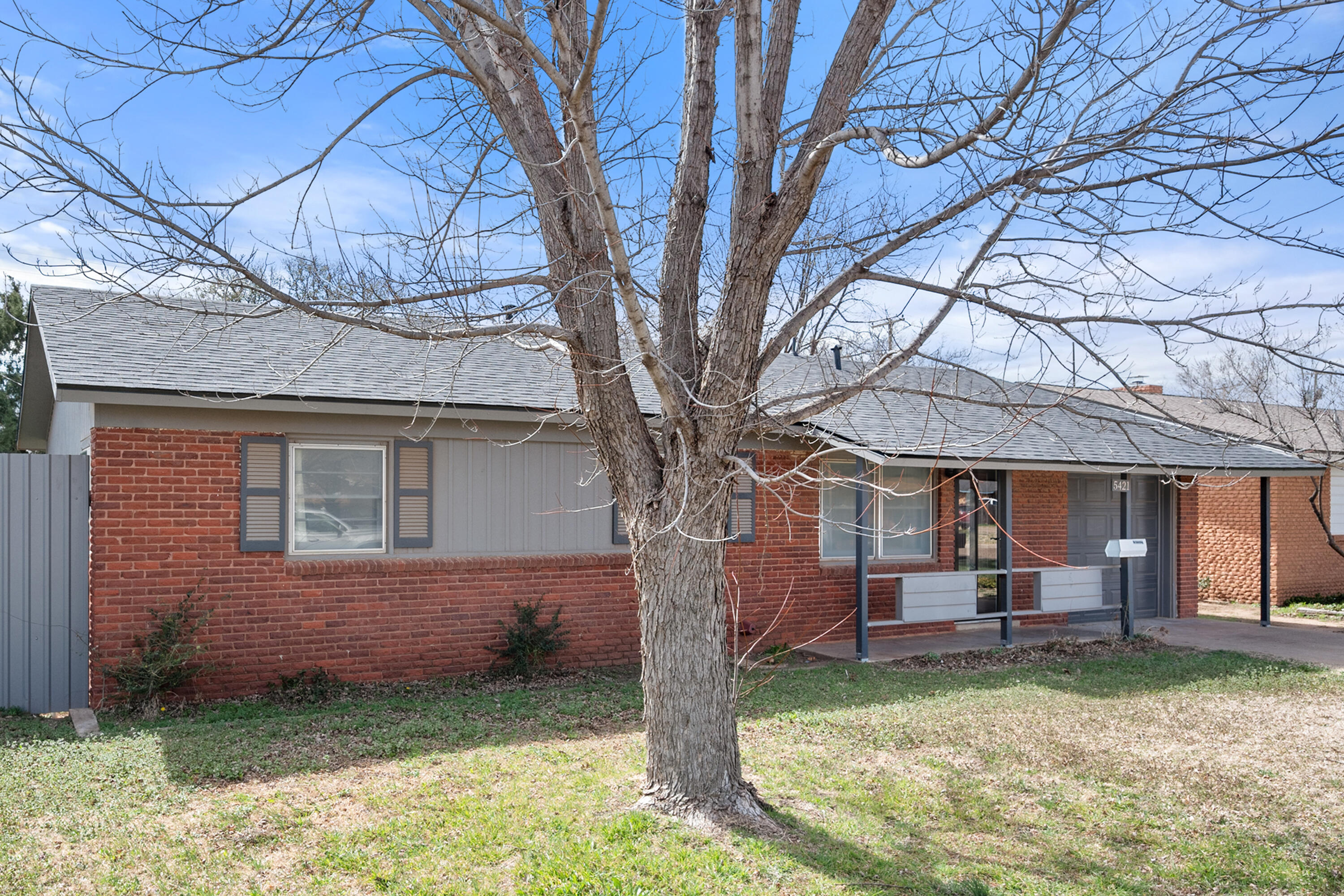 5421 43rd Street Lubbock, TX 79414 - Photo 5 of 40 a backyard of a house with barbeque oven fire pit table and chairs