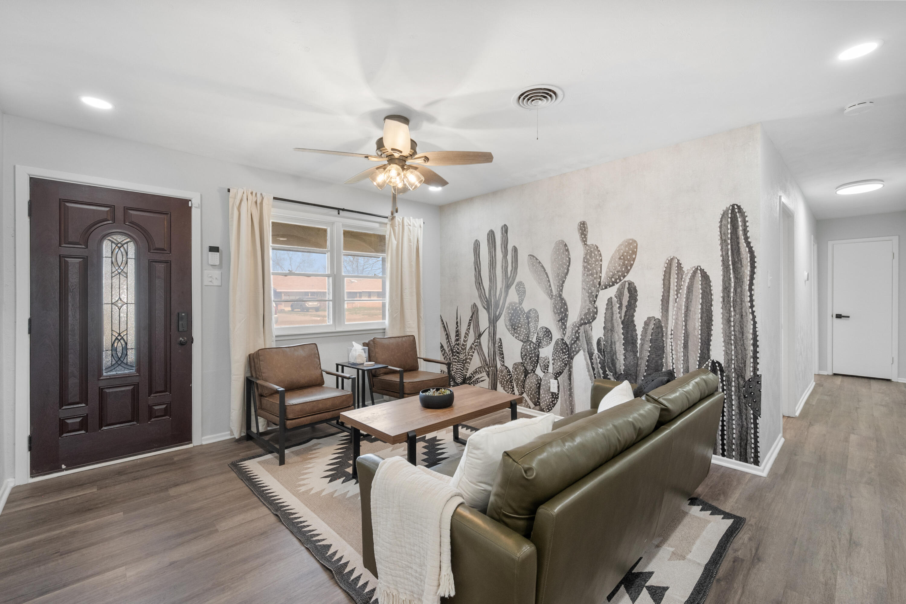 5421 43rd Street Lubbock, TX 79414 - Photo 8 of 40 a living room with furniture a ceiling fan and a window