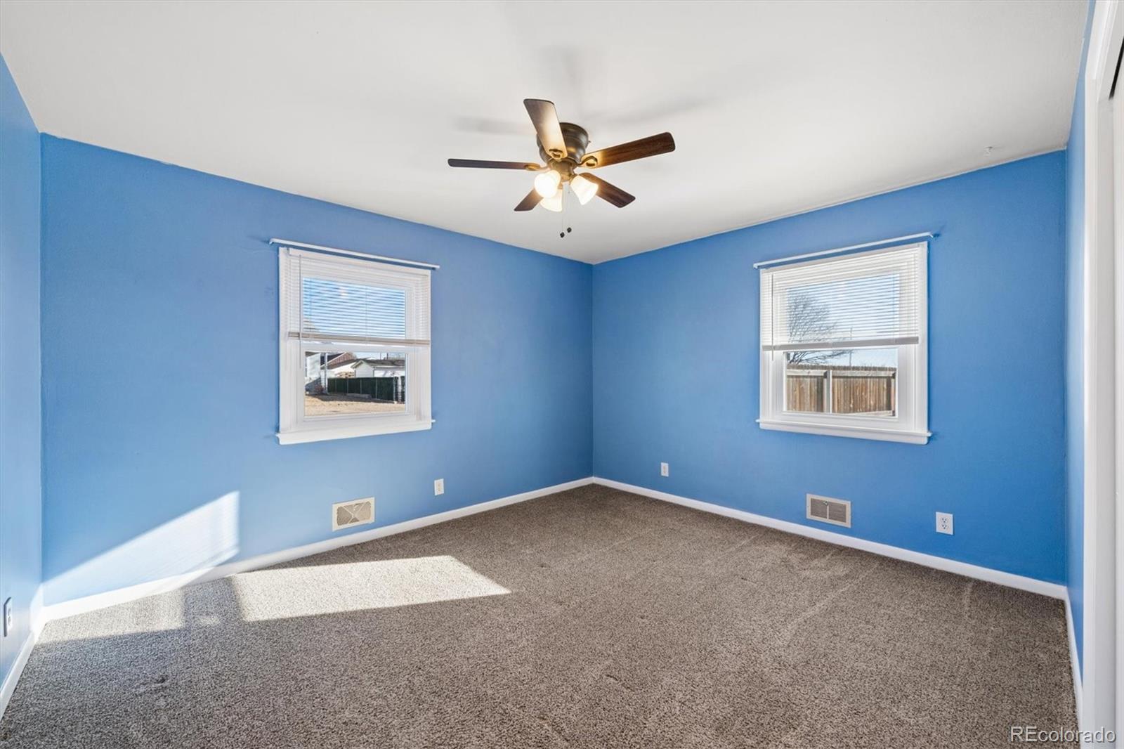 404 10th Street Gilcrest, CO 80623 - Photo 11 of 18 a view of a big room with ceiling fan and windows