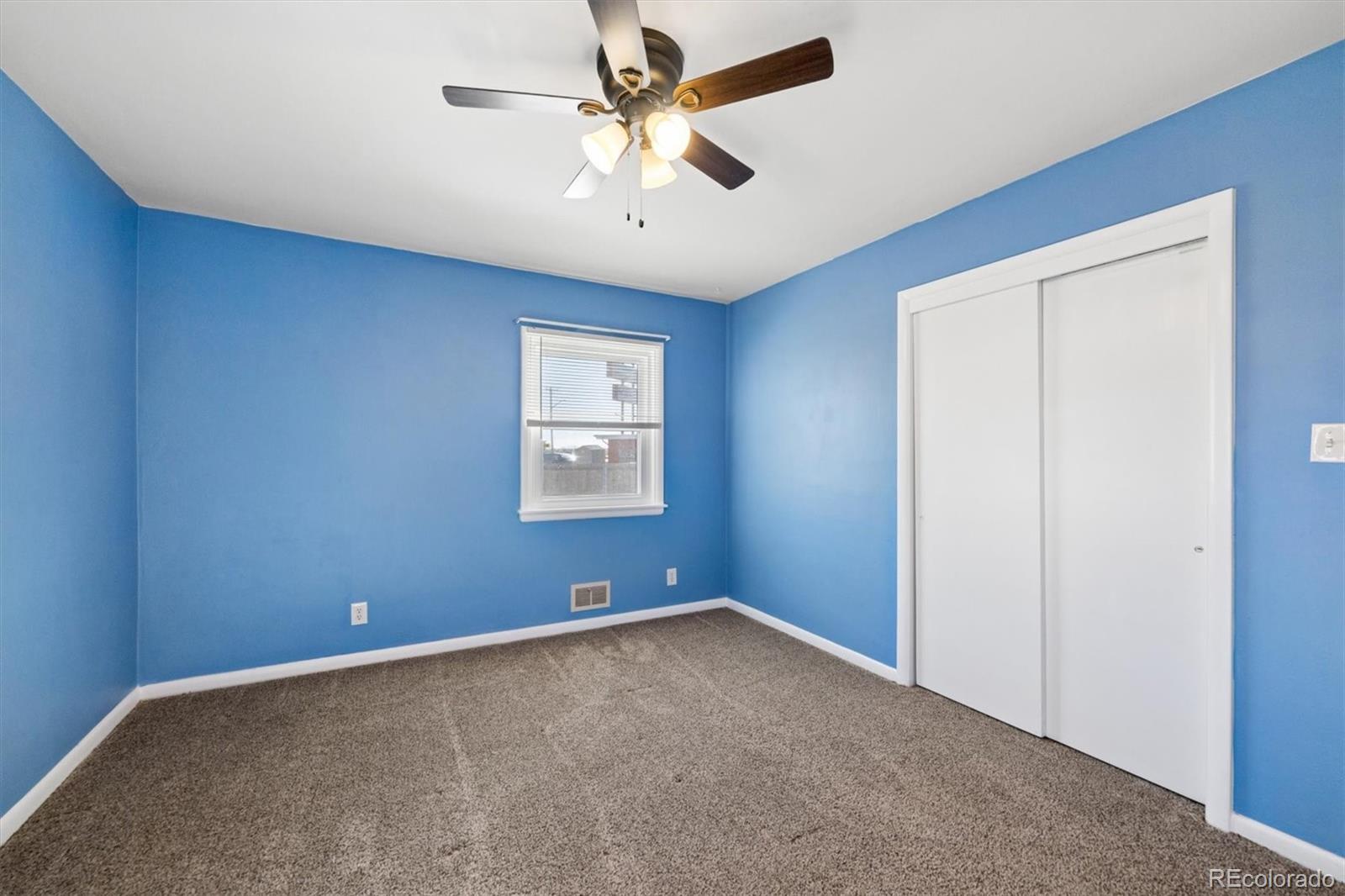 404 10th Street Gilcrest, CO 80623 - Photo 12 of 18 an empty room with windows and fan