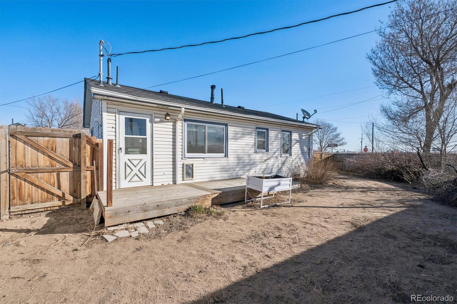 404 10th Street Gilcrest, CO 80623 - Photo 15 of 18 a front view of a house with garden