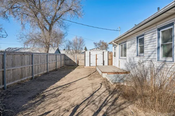 a view of a house with a wooden fence