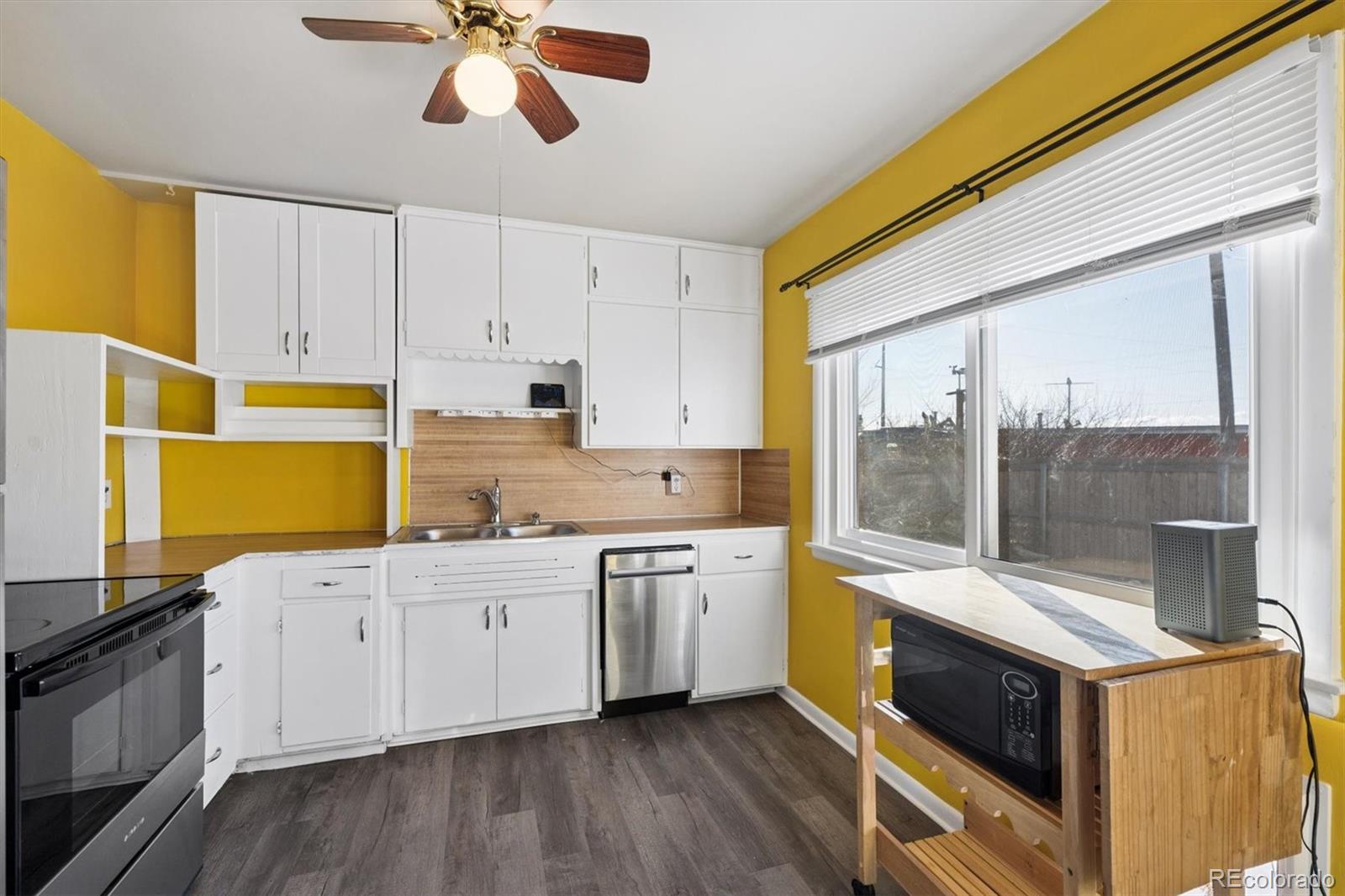 404 10th Street Gilcrest, CO 80623 - Photo 2 of 18 a kitchen with stainless steel appliances a stove a sink and a refrigerator