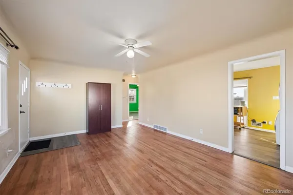 a view of an empty room with wooden floor