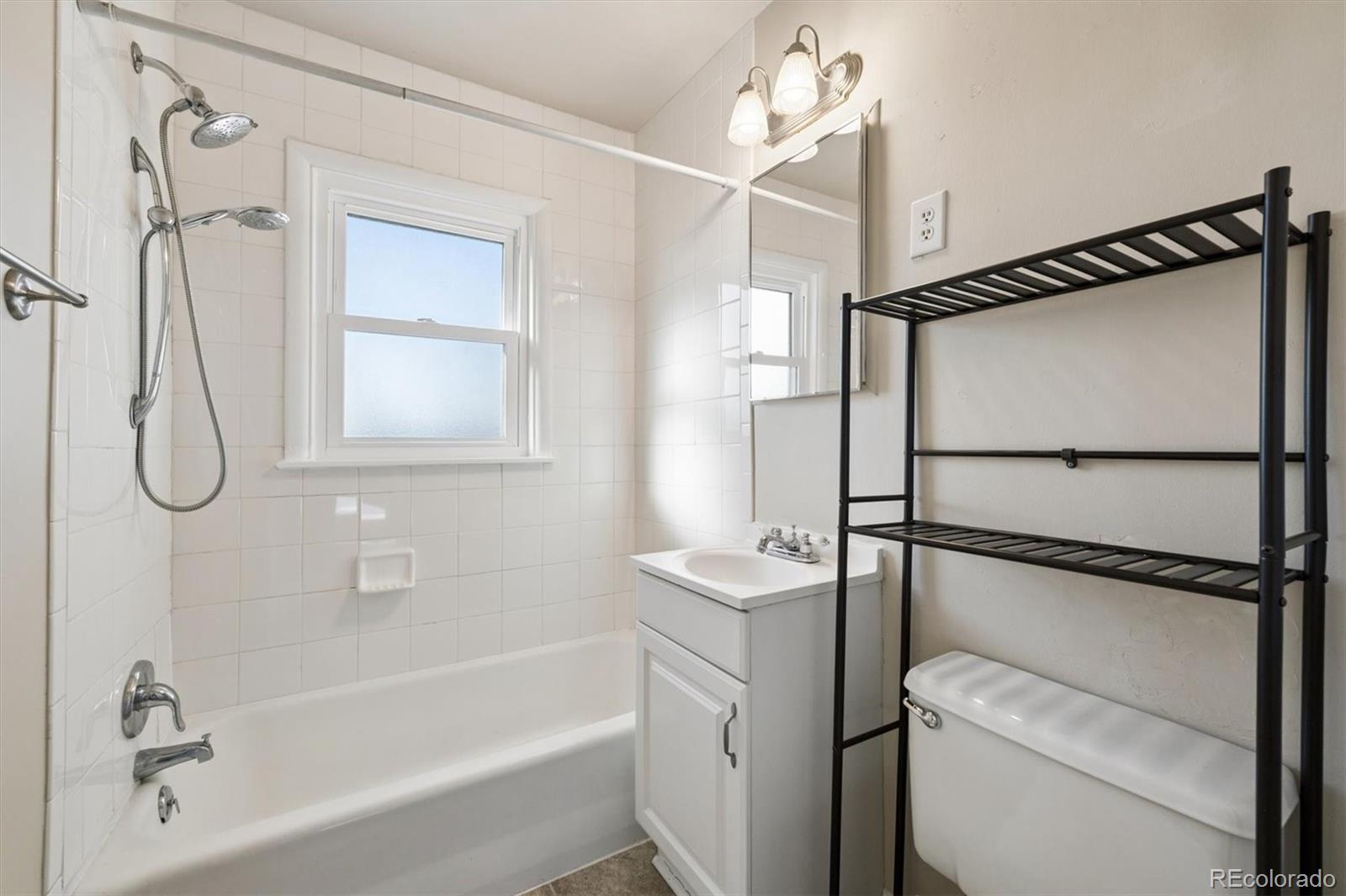 404 10th Street Gilcrest, CO 80623 - Photo 10 of 18 a bathroom with a shower a mirror and a shower