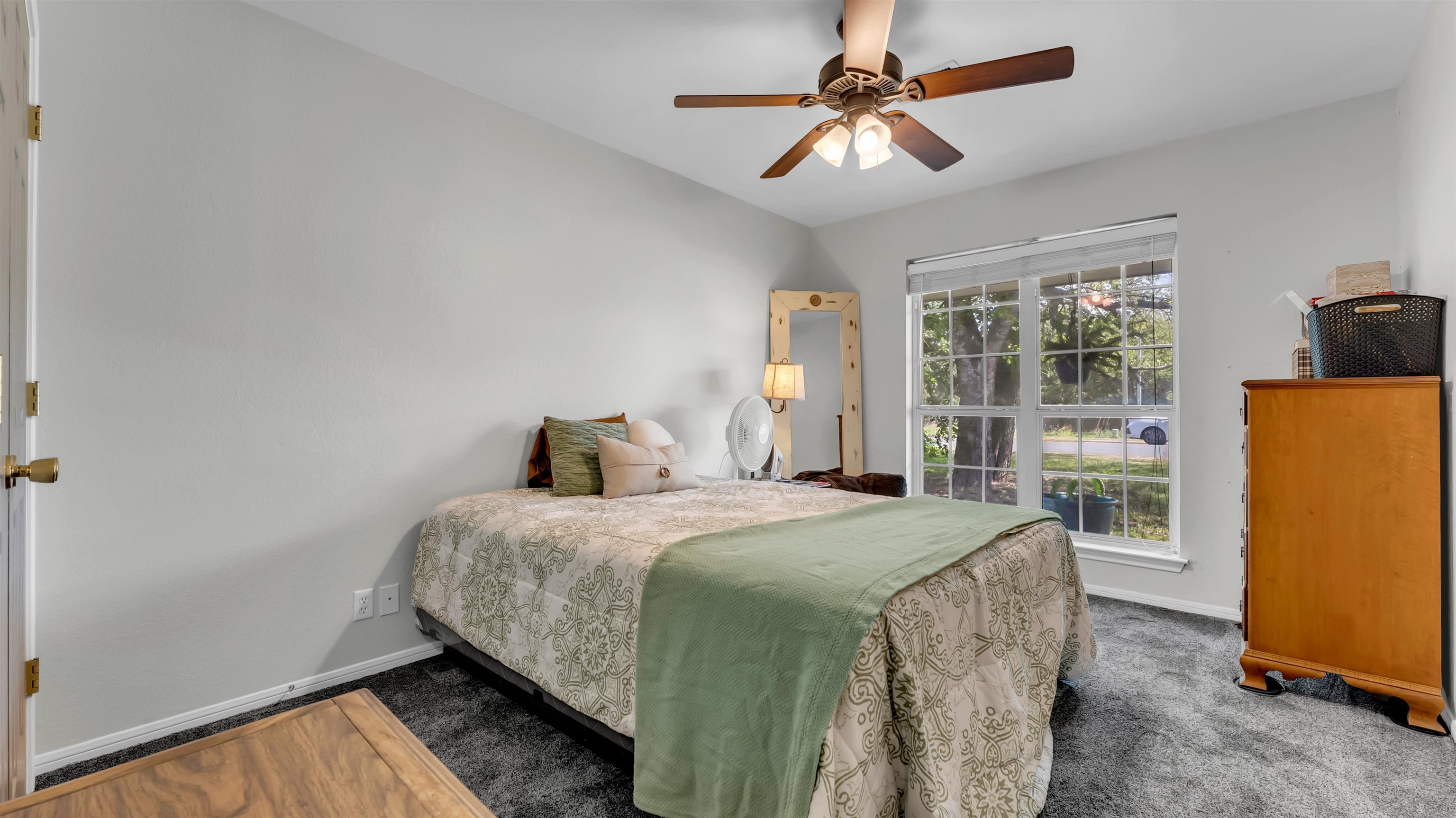 1004 East Johnson Street Burnet, TX 78611 - Photo 14 of 23 a bedroom with a bed and a chandelier