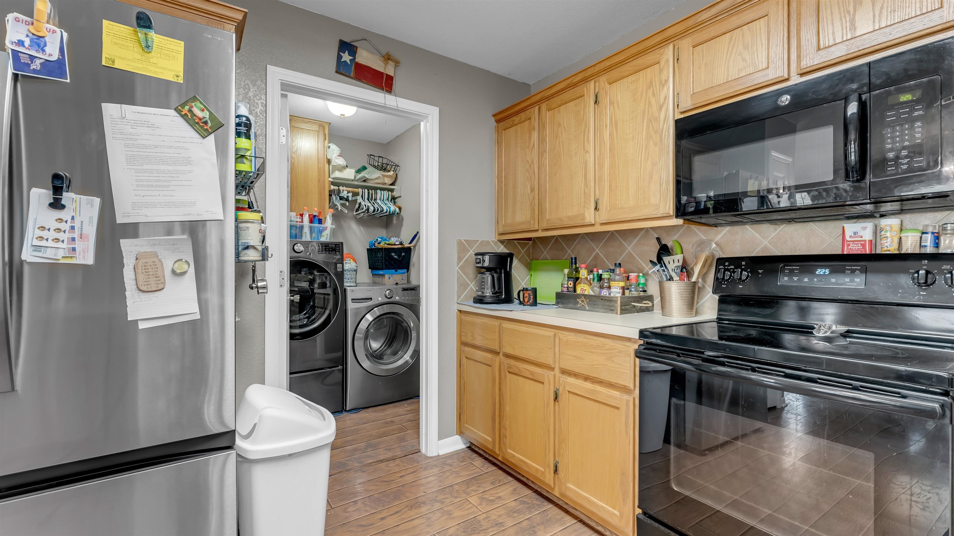 1004 East Johnson Street Burnet, TX 78611 - Photo 8 of 23 a kitchen with stainless steel appliances granite countertop a refrigerator a stove and a sink