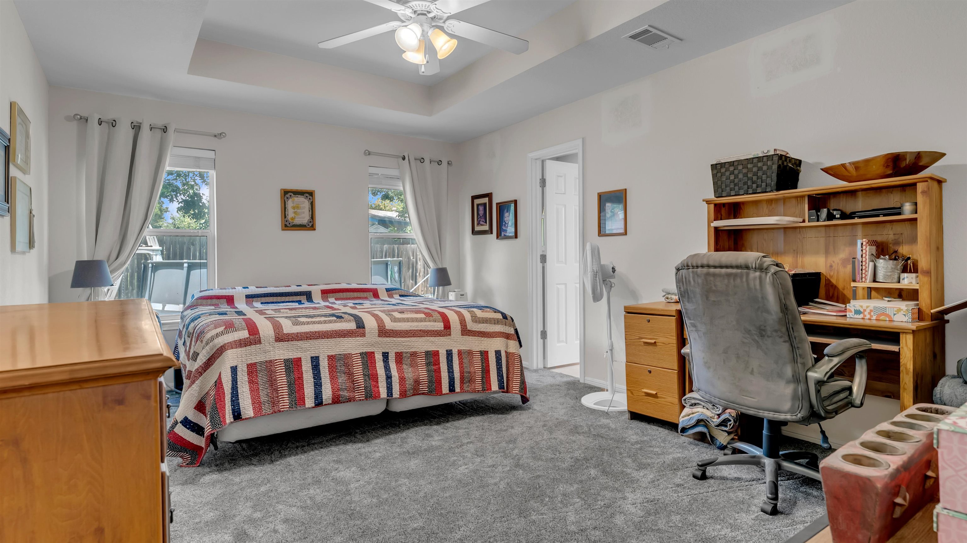 1004 East Johnson Street Burnet, TX 78611 - Photo 9 of 23 a bedroom with a bed and a chandelier