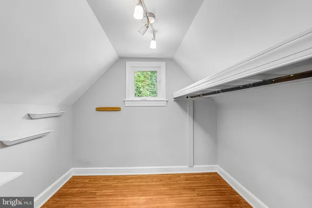 a view of a room with wooden floor and a window