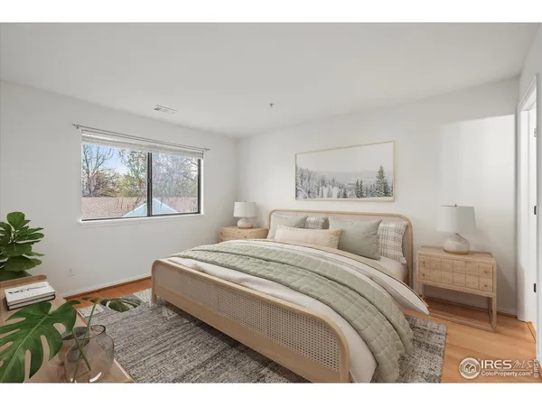 a bedroom with a bed and a painting on the wall