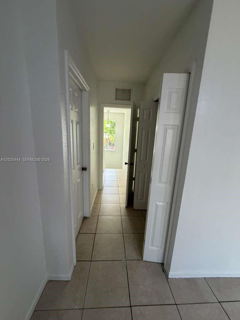 681 Southwest 7th Street, Unit 681 Florida City, FL 33034 - Photo 9 of 16 a view of a hallway to rooms