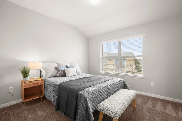 a bedroom with a bed and window