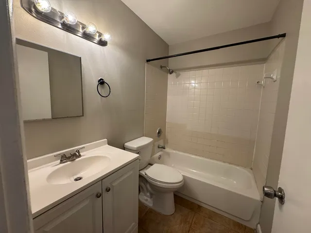 a bathroom with a sink mirror toilet and bathtub