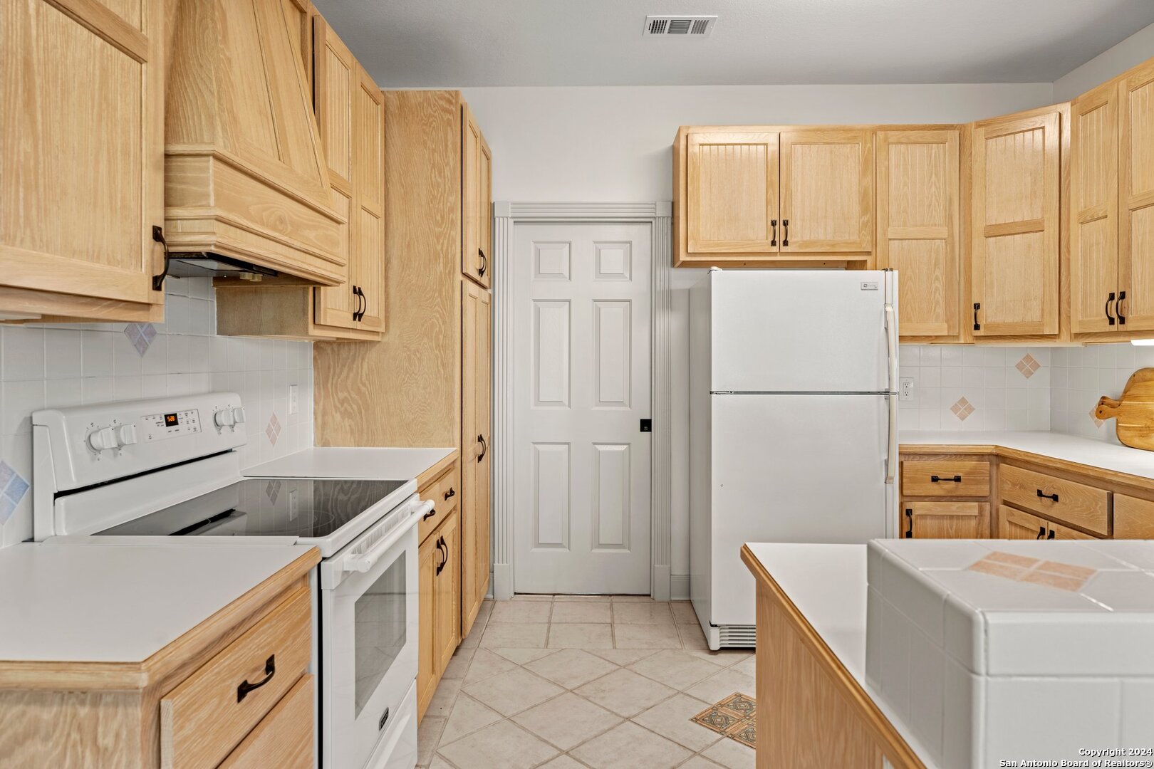 240 River Bend Road West Hunt, TX 78024 - Photo 14 of 45 a kitchen with a sink a stove and refrigerator