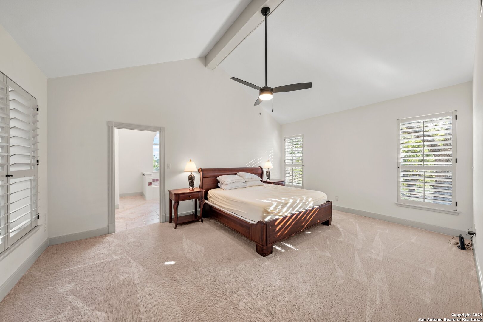 240 River Bend Road West Hunt, TX 78024 - Photo 16 of 45 a spacious bedroom with a bed chandelier and a window