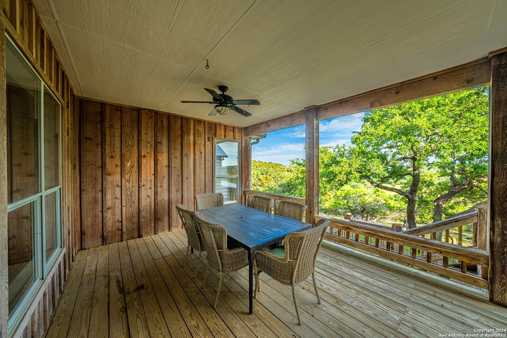 240 River Bend Road West Hunt, TX 78024 - Photo 24 of 45 a view of a balcony with furniture and wooden floor