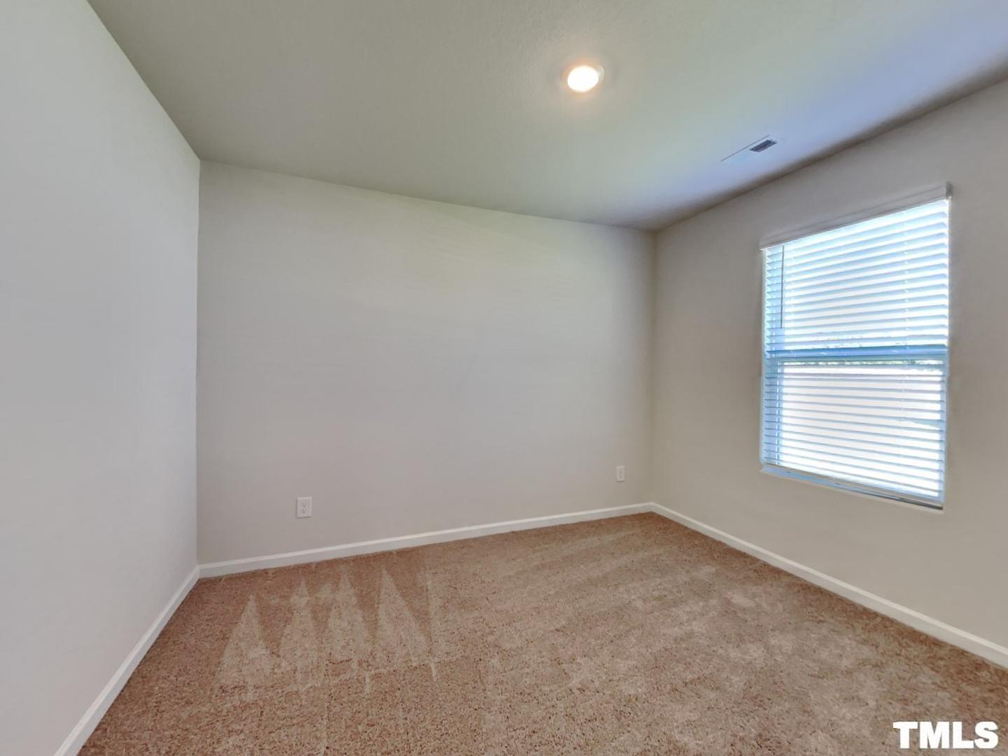 175 Coleshill Road Angier, NC 27501 - Photo 13 of 16 an empty room with a window
