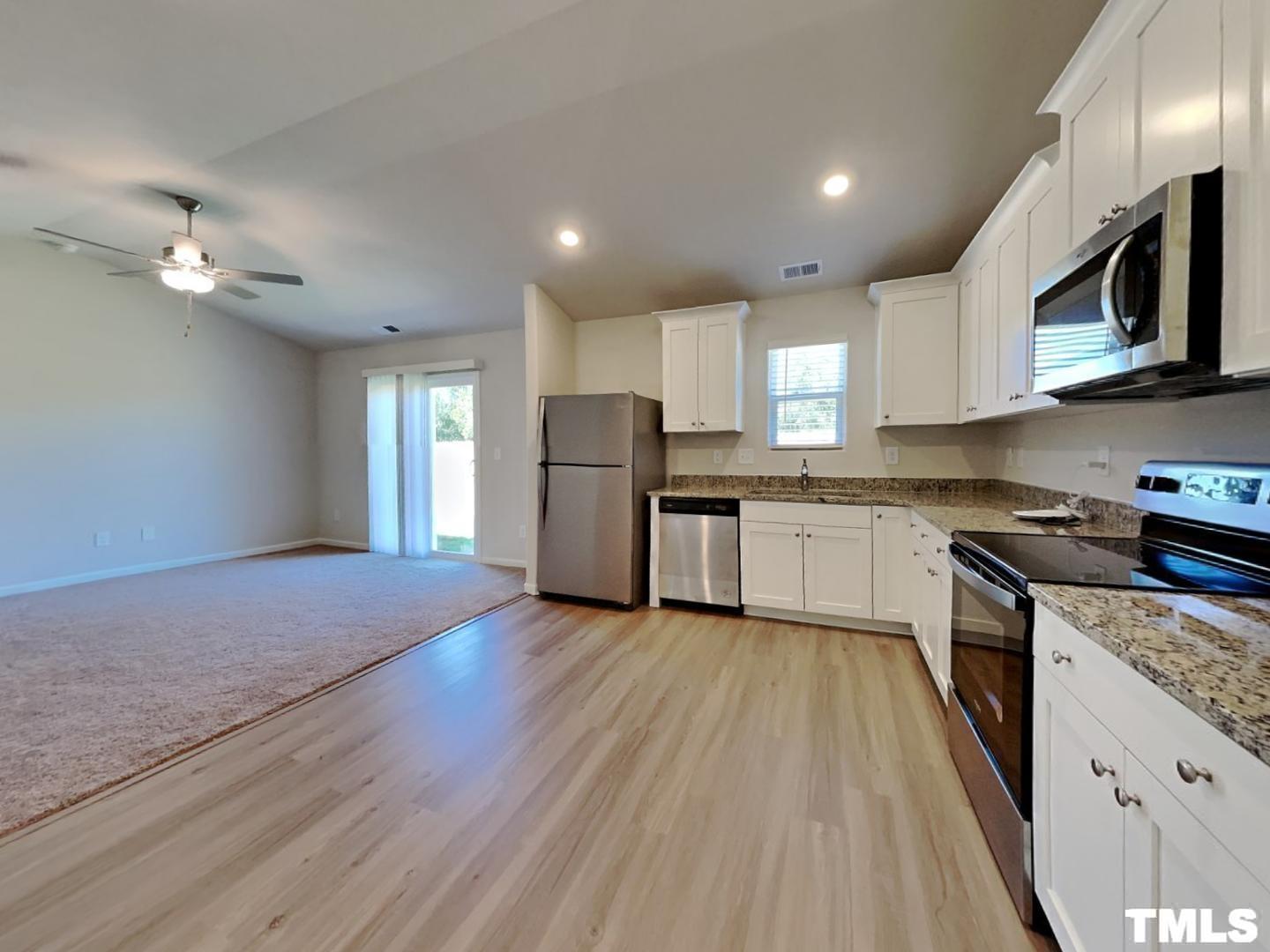 175 Coleshill Road Angier, NC 27501 - Photo 4 of 16 a kitchen with stainless steel appliances granite countertop wooden cabinets a window a sink and a stove