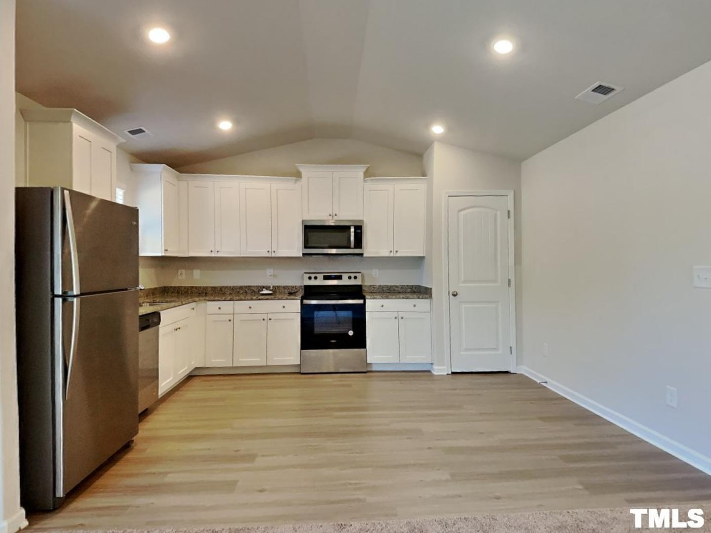 175 Coleshill Road Angier, NC 27501 - Photo 7 of 16 a kitchen with a refrigerator and a stove top oven